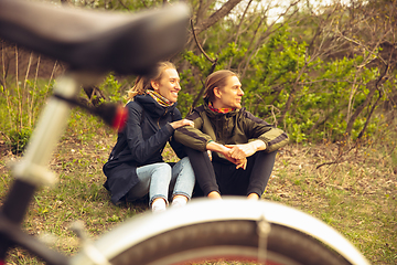 Image showing Best friends having fun near countryside park, riding bikes, spending time healthy