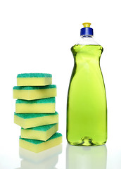 Image showing Bottle of green dishwashing liquid and sponges