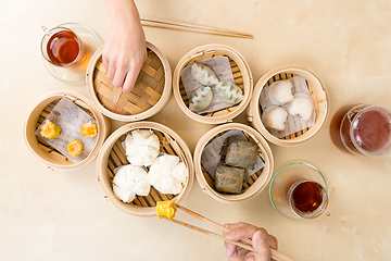 Image showing Top view of people eating dim sum