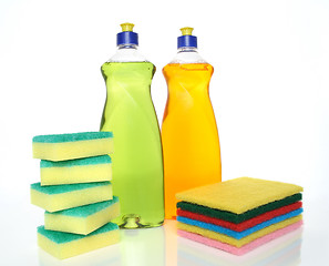 Image showing Bottles of dishwashing liquid and sponges