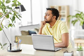 Image showing indian man with laptop thinking at home office