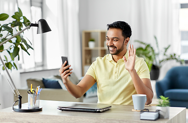 Image showing indian man having video call on smartphone at home