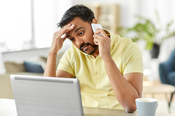 Image showing man calling on smartphone at home office