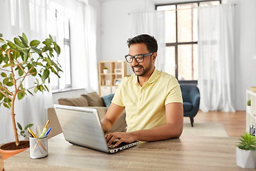 Image showing indian man with laptop working at home office