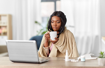Image showing sick woman with tea having video call on laptop