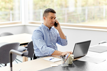 Image showing man calling on smartphone at home office