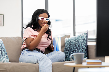 Image showing happy african american woman watching tv at home