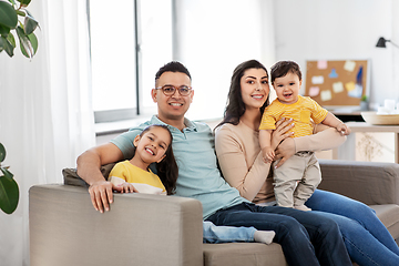 Image showing portrait of happy family sitting on sofa at home