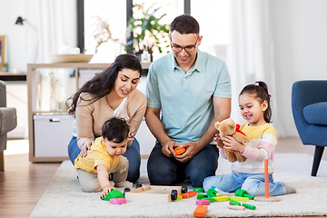 Image showing happy family palying with wooden toys at home