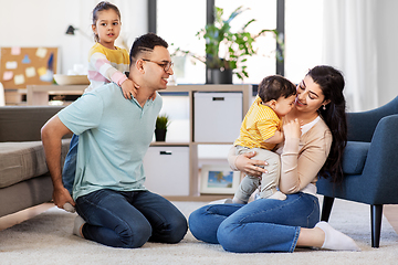 Image showing portrait of happy family sitting on sofa at home