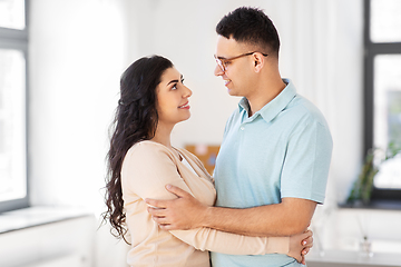 Image showing happy couple hugging at home