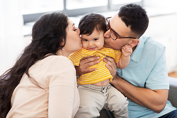 Image showing happy mother and father kissing baby son at home