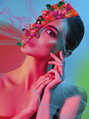 Image showing Portrait of beautiful young woman with modern floral design, inspiration artwork. Fashion, beauty concept. Neon light.