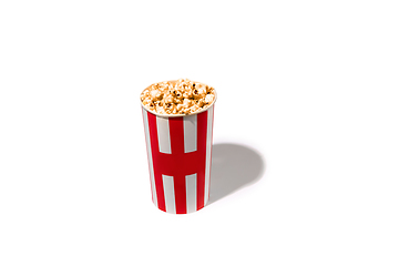 Image showing Striped white red bucket full of popcorn isolated on white studio background with copyspace