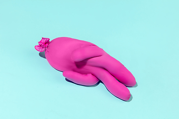 Image showing Life of rubber glove like a person - protective wear isolated on blue studio background