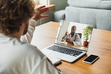 Image showing Manager or student working from home while being insulated or keep quarantine \'cause of coronavirus COVID-19. Online conference, meeting.