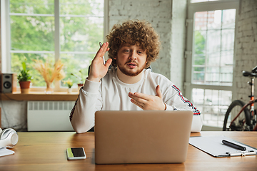 Image showing Manager or student working from home while being insulated or keep quarantine \'cause of coronavirus COVID-19. Online meeting.