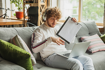 Image showing Manager or student working from home while being insulated or keep quarantine \'cause of coronavirus COVID-19. Conference online with colleague.