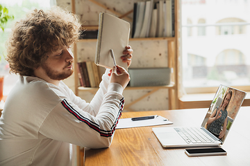 Image showing Manager or student working from home while being insulated or keep quarantine \'cause of coronavirus COVID-19. Online conference, meeting.