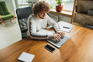 Image showing Manager or student working from home while being insulated or keep quarantine \'cause of coronavirus COVID-19. Typing text, report.