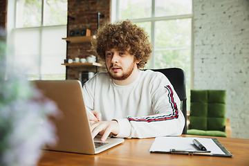 Image showing Manager or student working from home while being insulated or keep quarantine \'cause of coronavirus COVID-19. Typing text, report.