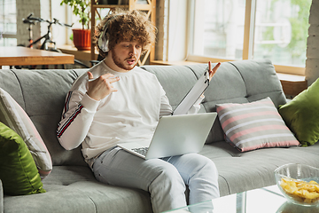 Image showing Manager or student working from home while being insulated or keep quarantine \'cause of coronavirus COVID-19. Conference online with colleague.