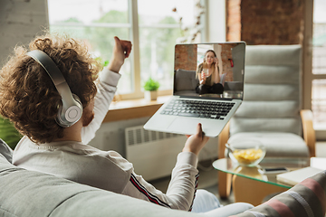 Image showing Manager or student working from home while being insulated or keep quarantine \'cause of coronavirus COVID-19. Conference online with colleague.