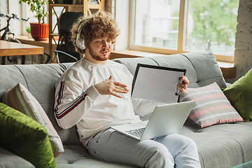 Image showing Manager or student working from home while being insulated or keep quarantine \'cause of coronavirus COVID-19. Conference online with colleague.