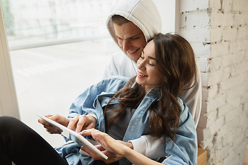 Image showing Quarantine lockdown, stay home concept - young beautiful caucasian couple enjoying new lifestyle during coronavirus worldwide health emergency