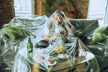 Image showing Senior man covered with plastic, eating fast food and drinking beer - environmental pollution by people concept