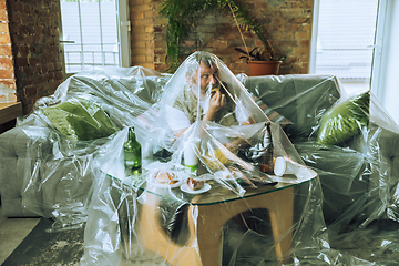 Image showing Senior man covered with plastic, eating fast food and drinking beer - environmental pollution by people concept