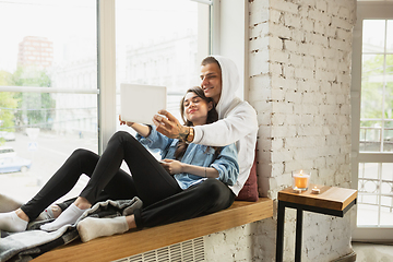 Image showing Quarantine lockdown, stay home concept - young beautiful caucasian couple enjoying new lifestyle during coronavirus worldwide health emergency