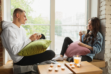 Image showing Quarantine lockdown, stay home concept - young beautiful caucasian couple enjoying new lifestyle during coronavirus worldwide health emergency