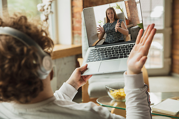 Image showing Manager or student working from home while being insulated or keep quarantine \'cause of coronavirus COVID-19. Conference online with colleague.