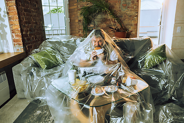 Image showing Senior man covered with plastic, eating fast food and drinking beer - environmental pollution by people concept