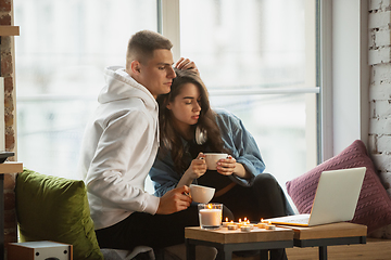 Image showing Quarantine lockdown, stay home concept - young beautiful caucasian couple enjoying new lifestyle during coronavirus worldwide health emergency