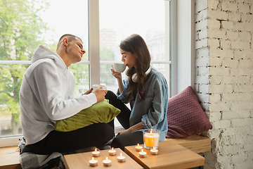 Image showing Quarantine lockdown, stay home concept - young beautiful caucasian couple enjoying new lifestyle during coronavirus worldwide health emergency