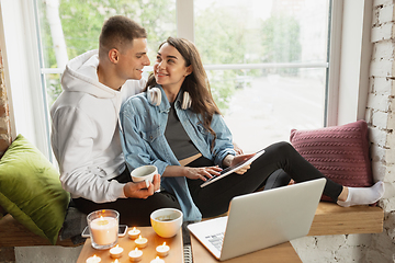 Image showing Quarantine lockdown, stay home concept - young beautiful caucasian couple enjoying new lifestyle during coronavirus worldwide health emergency