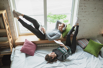 Image showing Quarantine lockdown, stay home concept - young beautiful caucasian couple enjoying new lifestyle during coronavirus worldwide health emergency