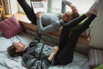 Image showing Quarantine lockdown, stay home concept - young beautiful caucasian couple enjoying new lifestyle during coronavirus worldwide health emergency