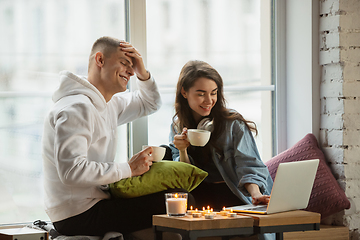 Image showing Quarantine lockdown, stay home concept - young beautiful caucasian couple enjoying new lifestyle during coronavirus worldwide health emergency