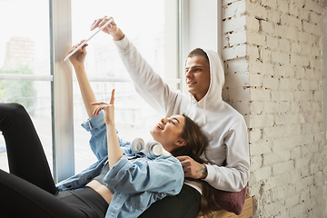 Image showing Quarantine lockdown, stay home concept - young beautiful caucasian couple enjoying new lifestyle during coronavirus worldwide health emergency