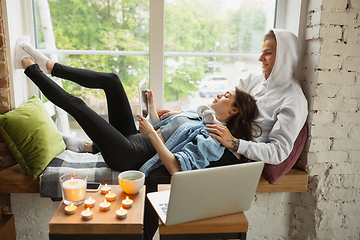 Image showing Quarantine lockdown, stay home concept - young beautiful caucasian couple enjoying new lifestyle during coronavirus worldwide health emergency