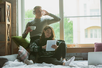 Image showing Quarantine lockdown, stay home concept - young beautiful caucasian couple enjoying new lifestyle during coronavirus worldwide health emergency