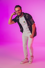 Image showing Young caucasian musician, dancer, partyhost in neon light