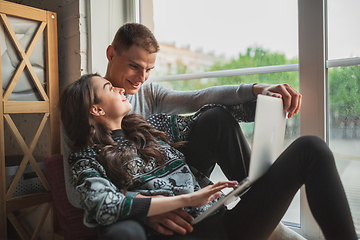 Image showing Quarantine lockdown, stay home concept - young beautiful caucasian couple enjoying new lifestyle during coronavirus worldwide health emergency