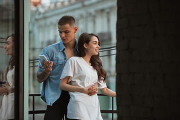 Image showing Quarantine lockdown, stay home concept - young beautiful caucasian couple enjoying new lifestyle during coronavirus worldwide health emergency