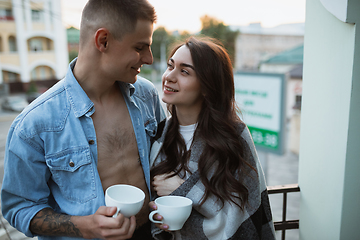 Image showing Quarantine lockdown, stay home concept - young beautiful caucasian couple enjoying new lifestyle during coronavirus worldwide health emergency