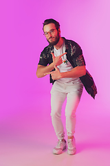 Image showing Young caucasian musician, dancer, partyhost in neon light