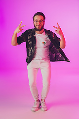 Image showing Young caucasian musician, dancer, partyhost in neon light